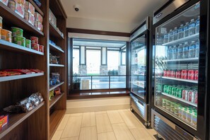 A grocery store with shelves stocked with various products, a refrigerated display case, and a view through a large window. - Holiday Inn Express Mill Valley San Francisco Area by IHG (Mill Valley)