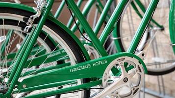 A green bicycle with the text "GRADUATE HOTELS" on the frame.