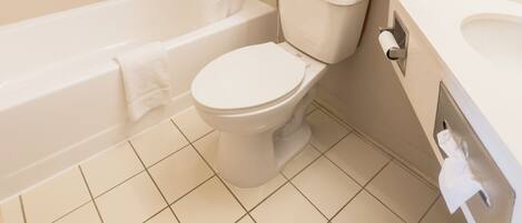 A bathroom with a bathtub, toilet, and sink.