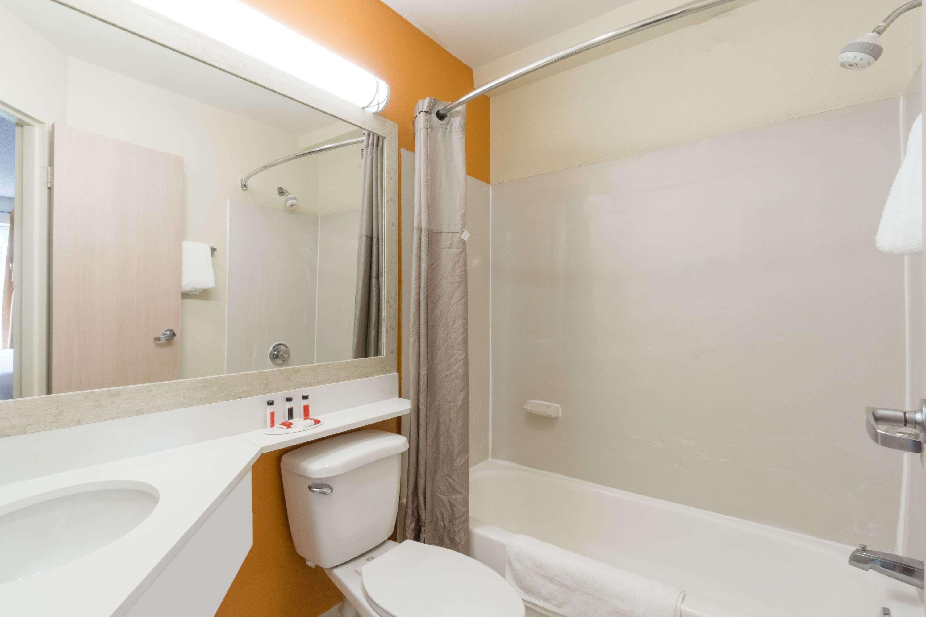 A bathroom with a toilet, sink, and bathtub.