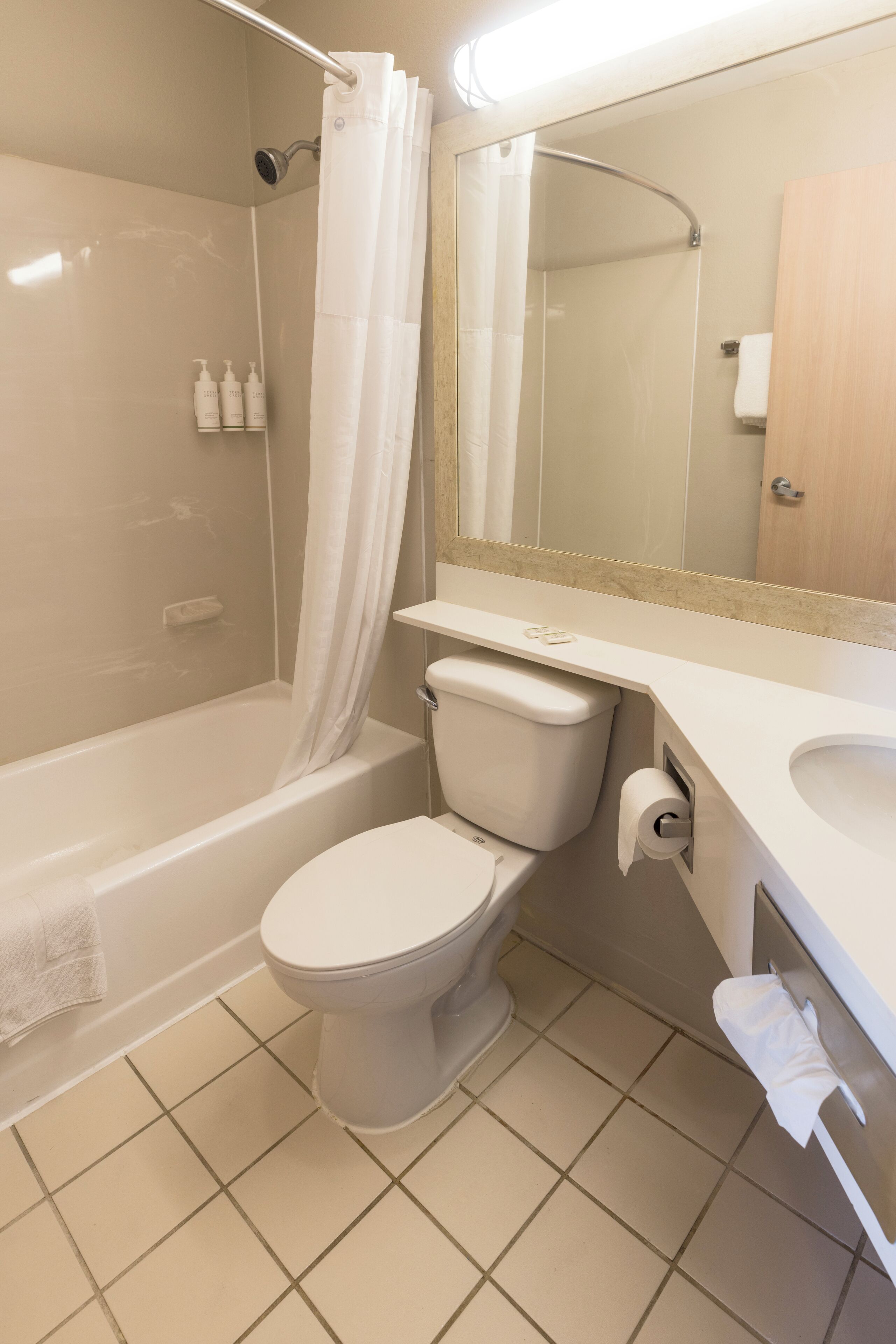 A bathroom with a bathtub, toilet, and sink.