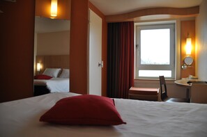 Premium bedding, desk, laptop workspace, blackout drapes