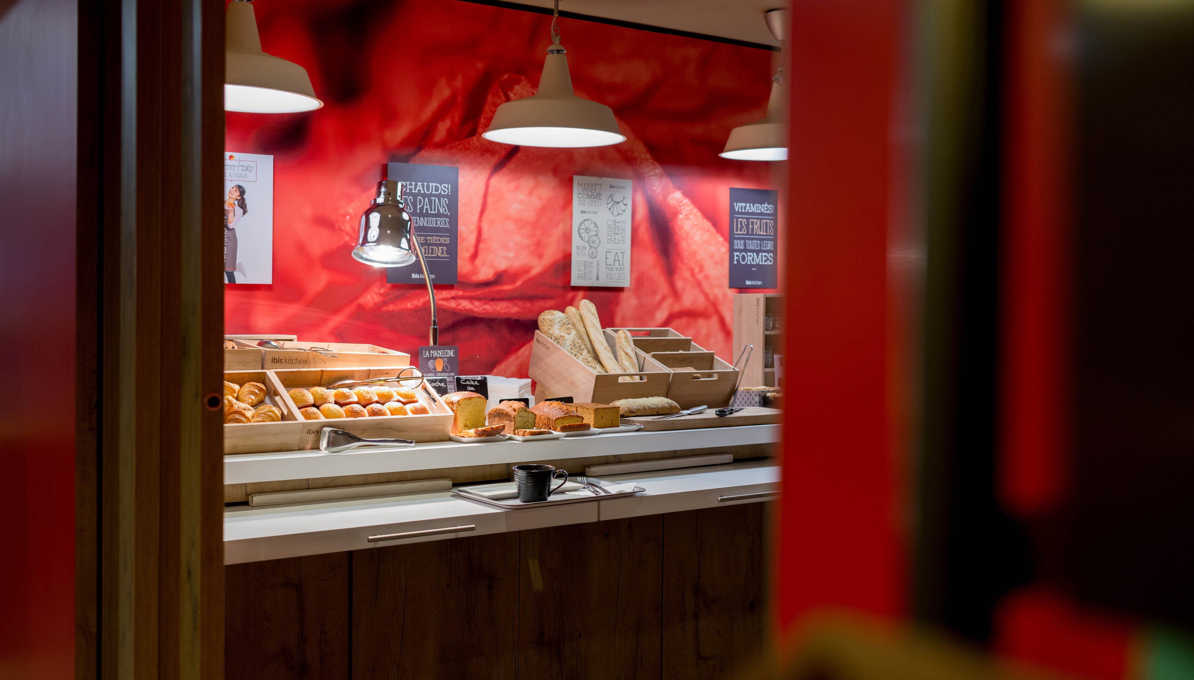 A bakery display with various baked goods and a menu board.
