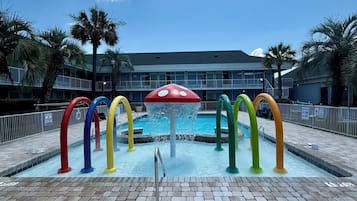 Una piscina al aire libre de temporada, sombrillas