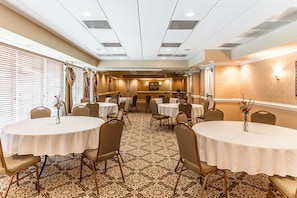 A conference room with round tables, chairs, and patterned carpet. - Quality Inn & Suites Georgetown (Georgetown)