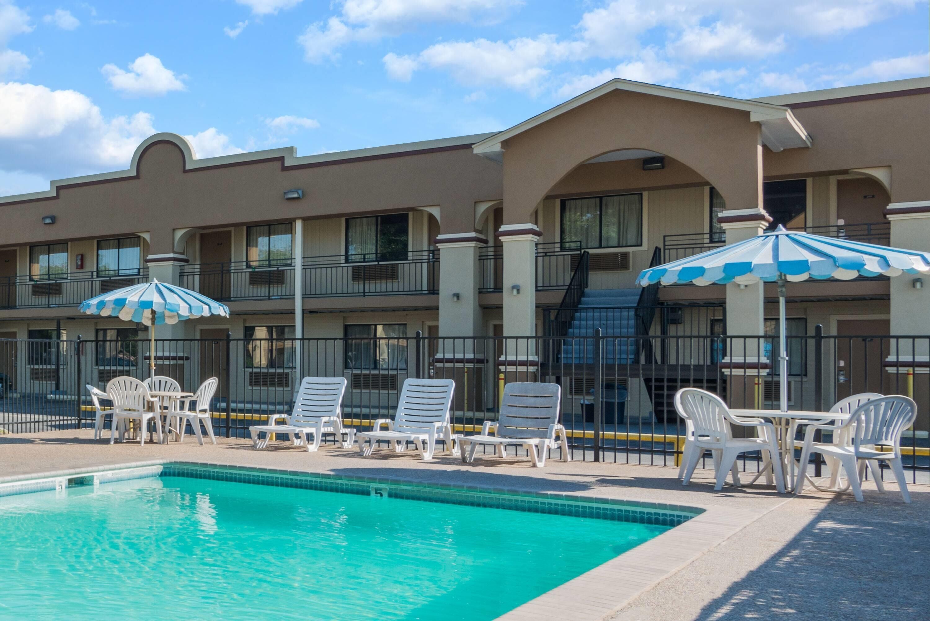 Outdoor pool, open 10 AM to 10 PM, pool umbrellas, pool loungers