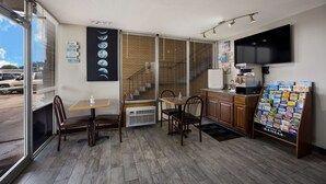 A restaurant with a brick wall, wooden flooring, a staircase, and a menu board. - Travelodge by Wyndham Oakley (Oakley)