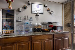A breakfast area with a sign for continental breakfast from 07:00 AM to 09:00 AM.
