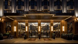 The entrance of Hilton Vienna Plaza with a modern facade, large glass doors, and a well-lit interior. - Hilton Vienna Plaza (Vienna)