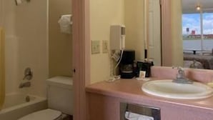 A bathroom with a toilet, sink, and shower. - Days Inn by Wyndham Newport (Newport)