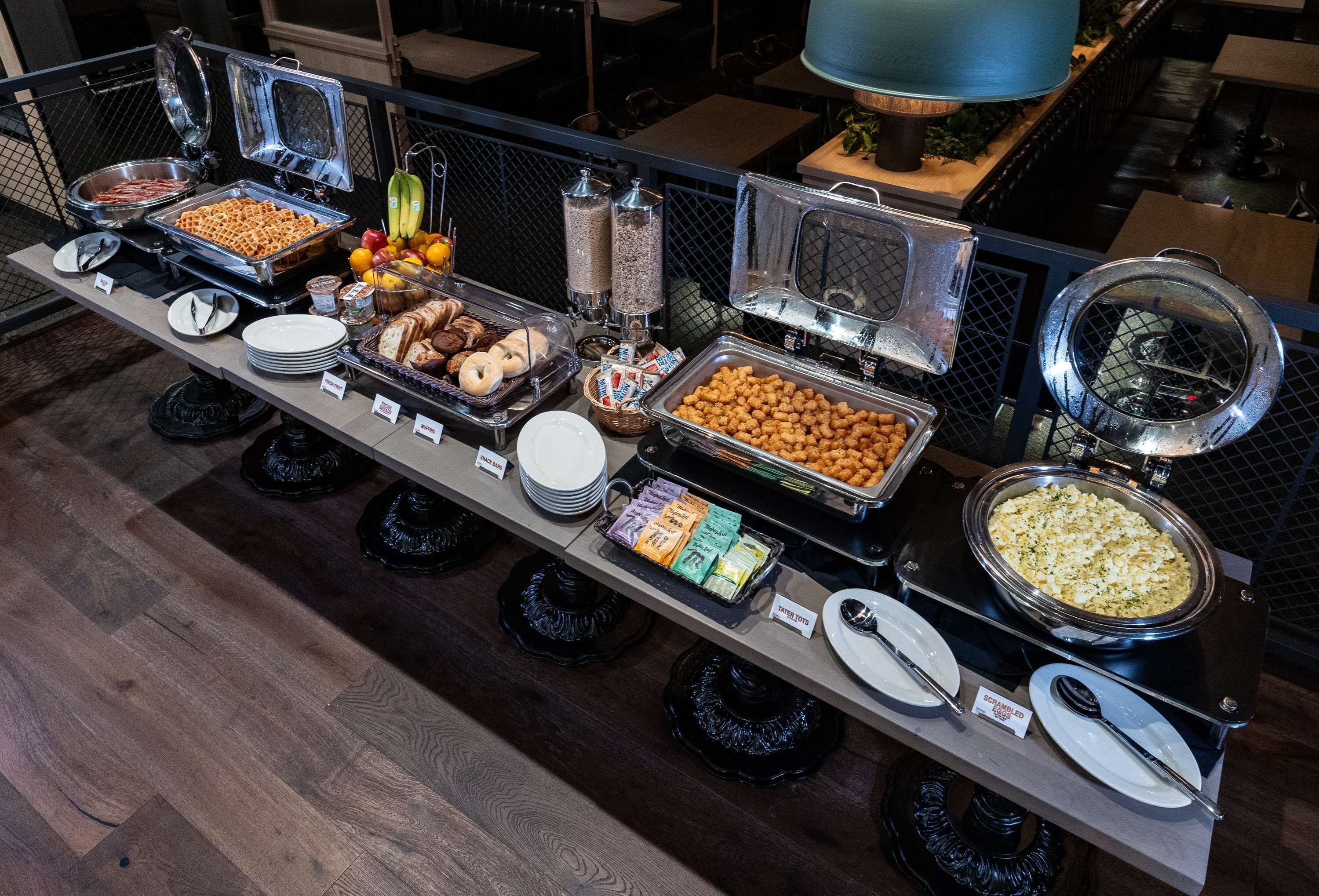A buffet with various food items and condiments.