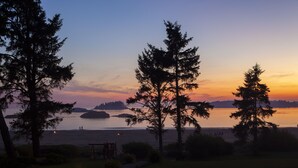 A serene lakeside view with tall trees and a wooden deck. - Best Western Plus Tin Wis Resort (Tofino)