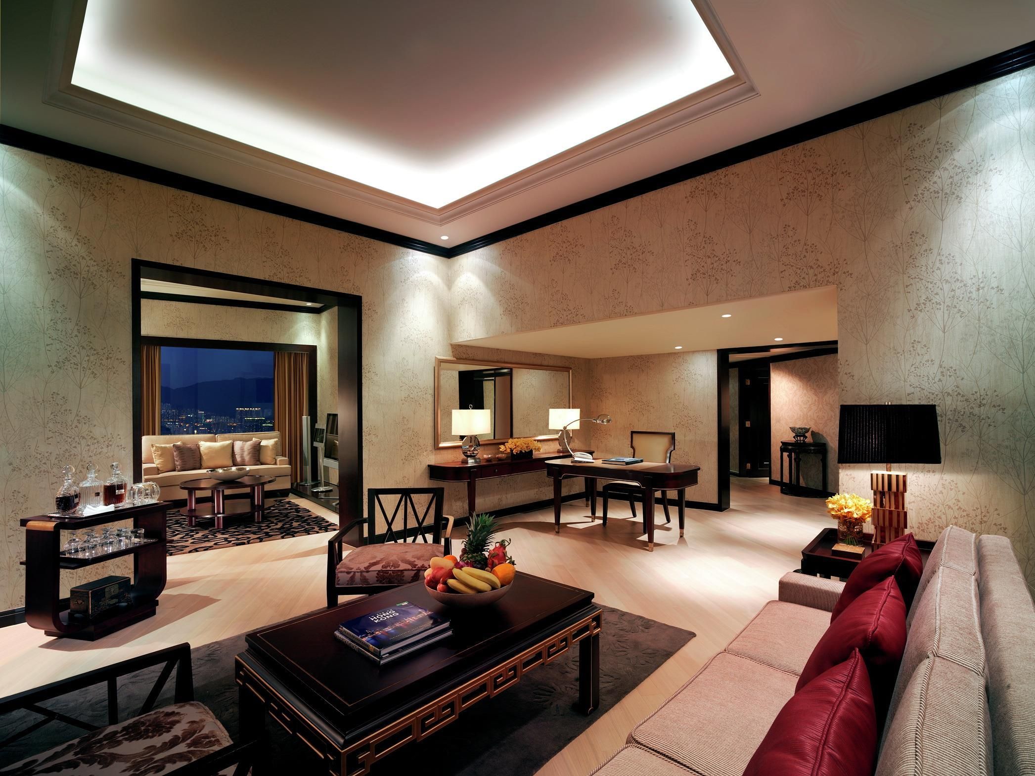 A modern living room with a sofa, coffee table, and dining area.