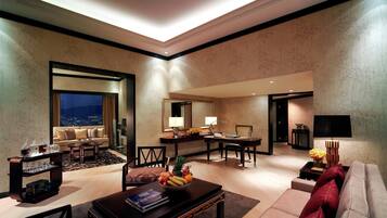 A modern living room with a sofa, coffee table, and dining area.