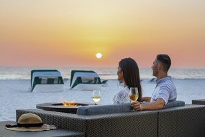 On the beach, white sand, beach cabanas, sun-loungers