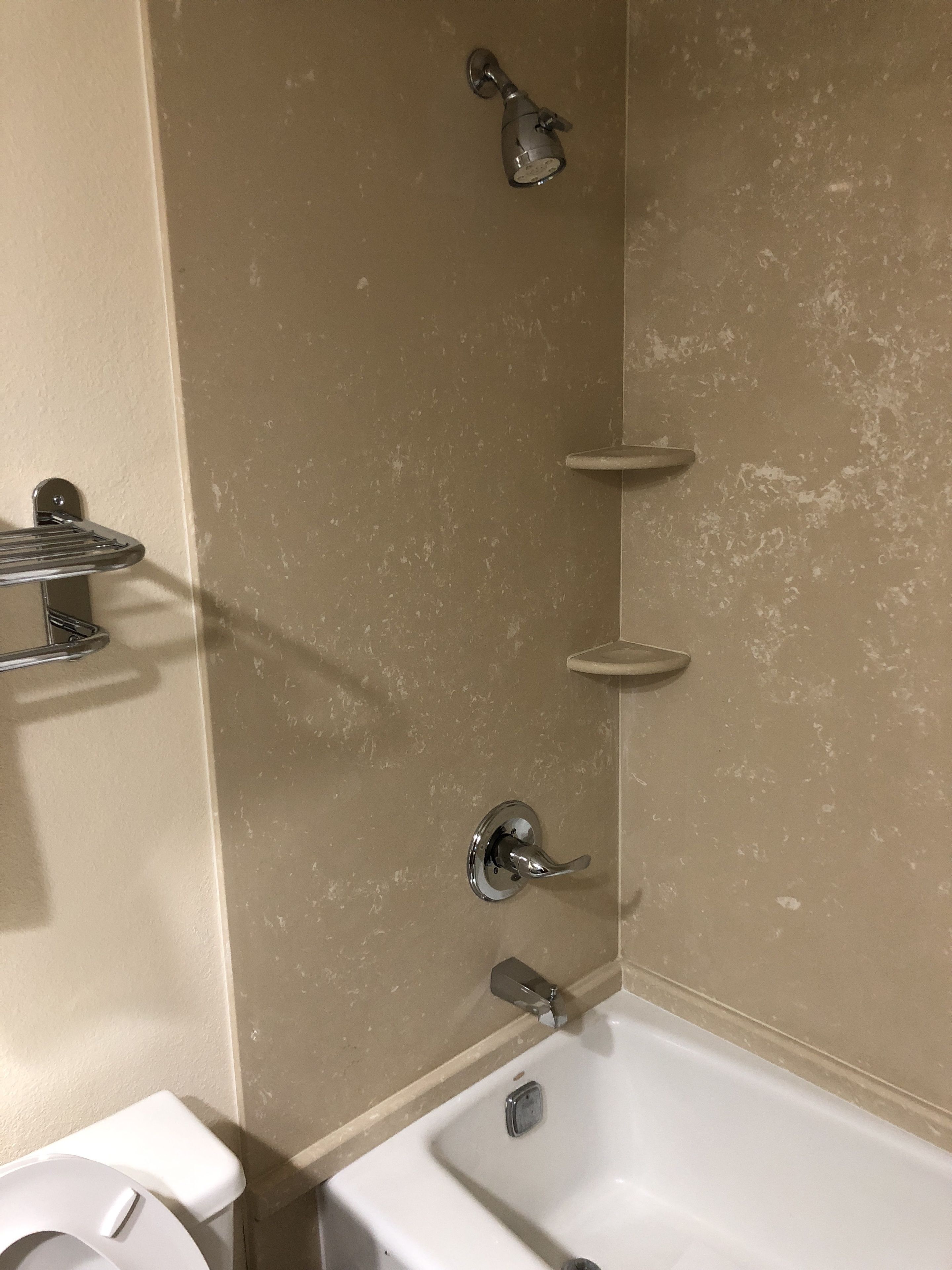 A bathroom with a bathtub, a shower, and a toilet.