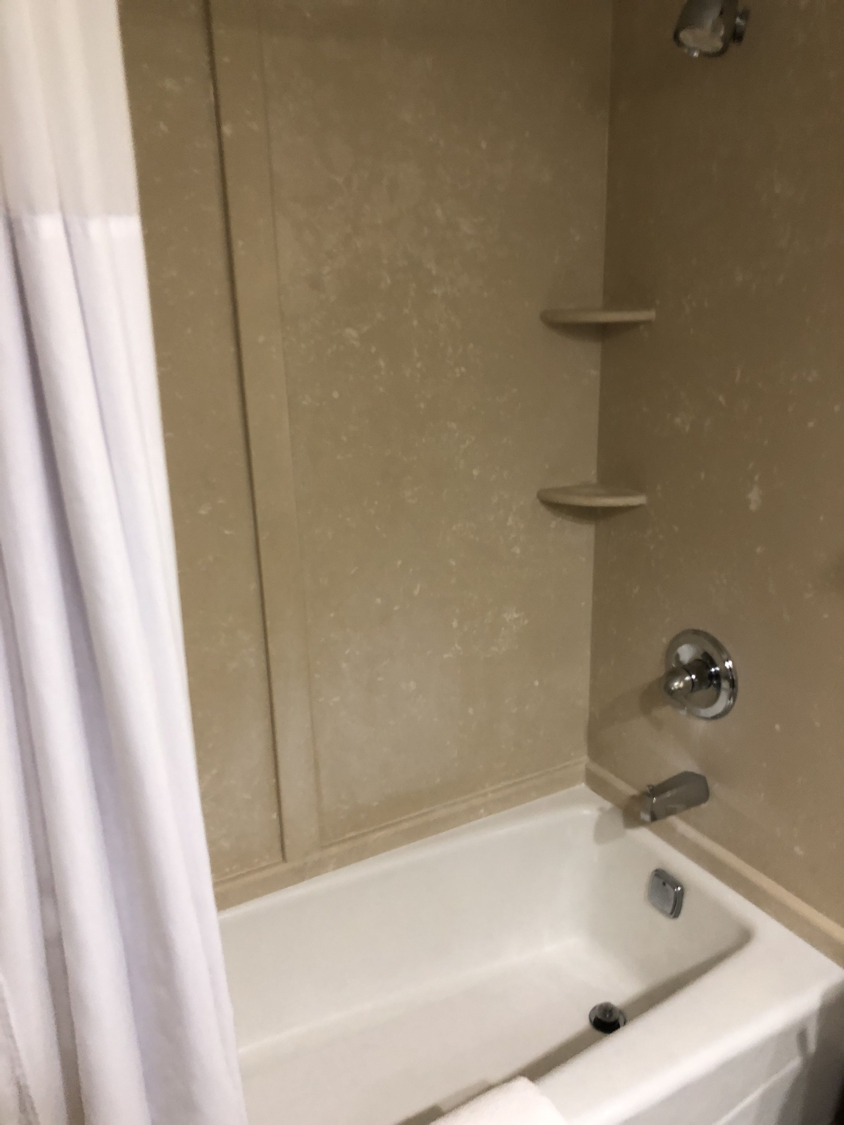 Un baño con bañera, ducha y retrete.