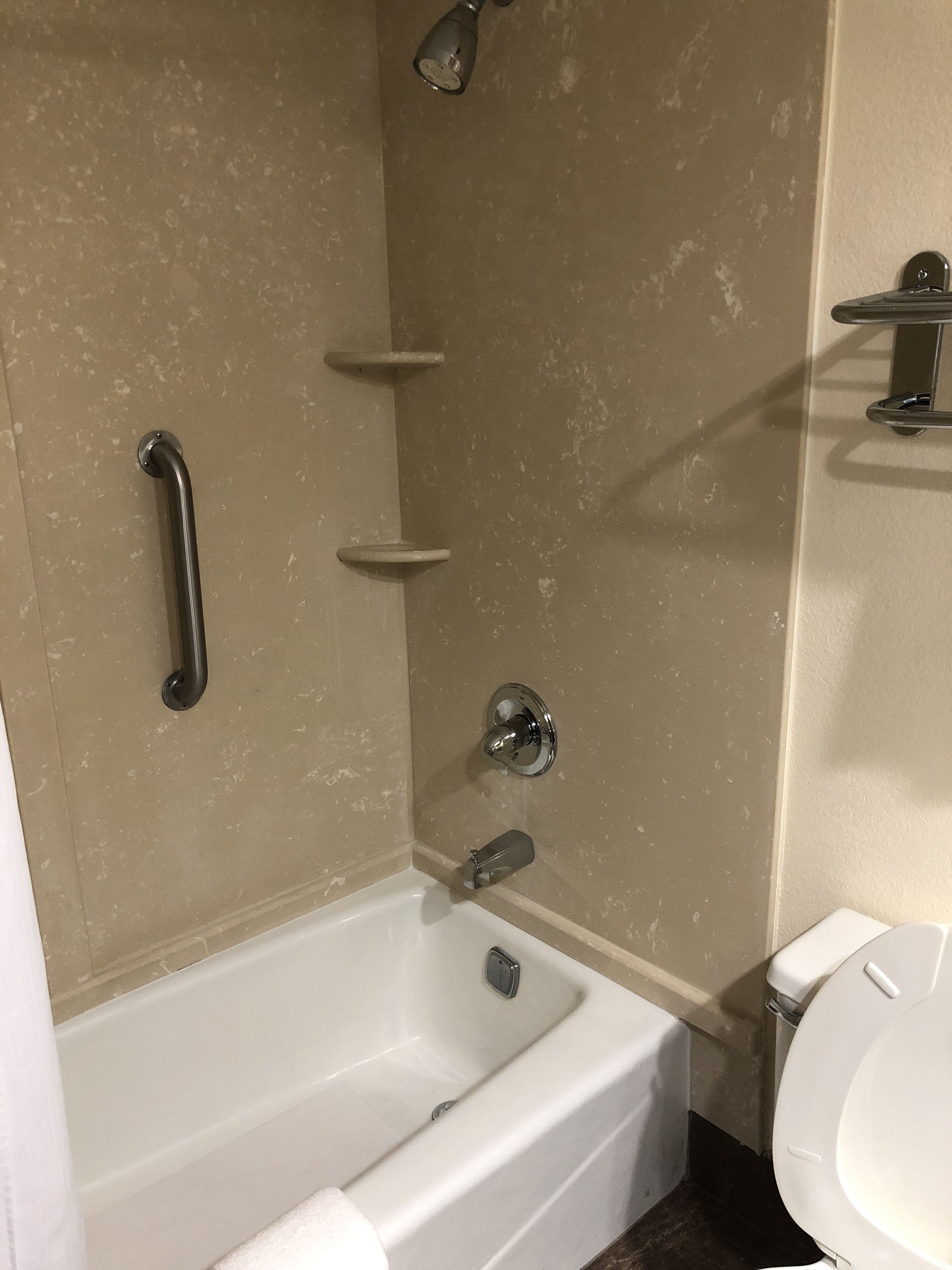 A bathroom with a bathtub, a shower, and a toilet.