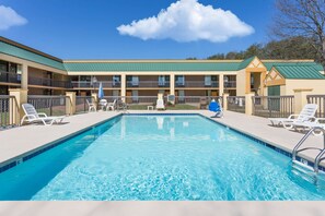 Relax by the pool surrounded by lounge chairs and umbrellas.