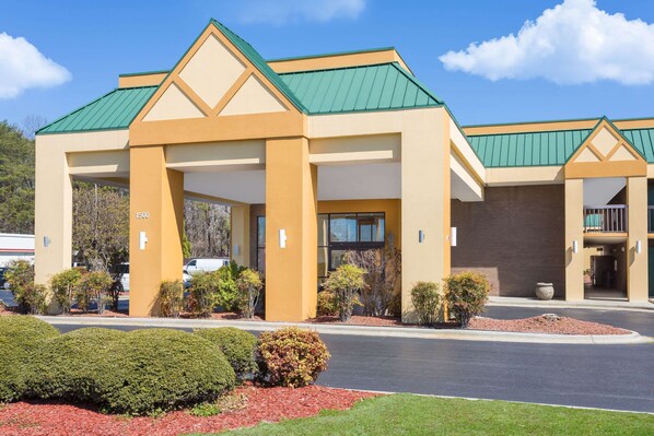 Stunning hotel entrance with a central address and beautifully manicured grounds.
