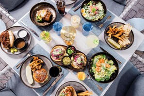 A table with various dishes including burgers, fries, and salads, suggesting a casual dining setting. - Innisbrook Resort (Palm Harbor)