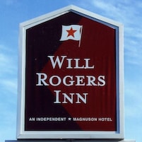 Placa do Will Rogers Inn com fundo vermelho e letras brancas.