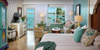 A waterfront hotel with a long pier, multiple balconies, and a view of the ocean. at Ocean Key Resort - A Noble House Resort