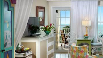 Una habitación con escritorio, silla y vista al océano.