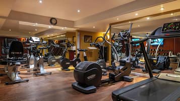 A gym with treadmills, ellipticals, and weight machines.