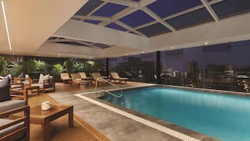 Indoor pool, open 8:00 AM to 10:00 PM, pool loungers