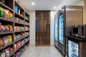 A snack aisle with various packaged goods and a refrigerated display. - Holiday Inn Express & Suites Santa Ana - Orange County by IHG (Santa Ana)