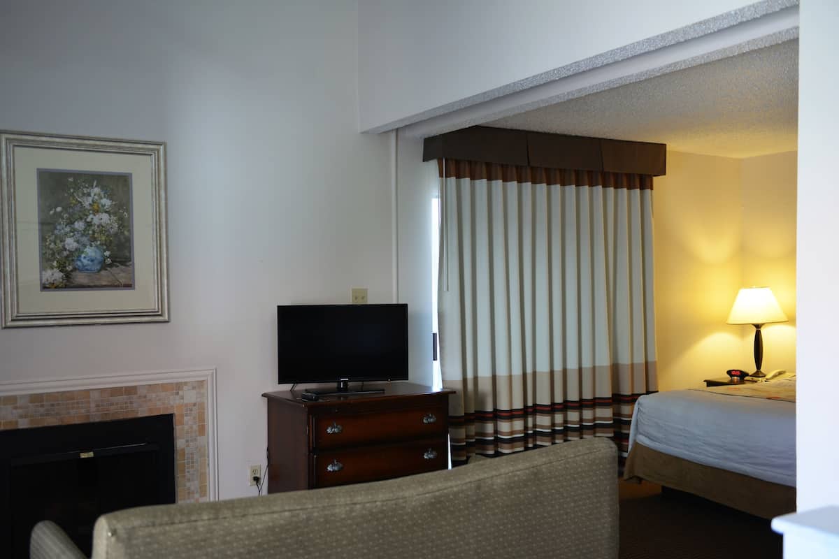 suite, 2 queen beds, non smoking (one-bedroom) | living area | 27-inch flat-screen tv with cable channels, tv, fireplace