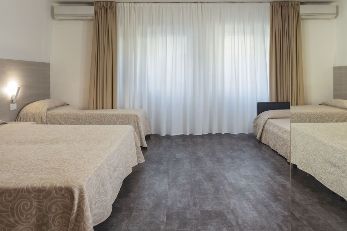 Quadruple Room, Annex Building | Minibar, in-room safe, desk, blackout drapes