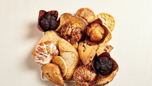 A variety of pastries and bread on a white plate. - Holiday Inn Hotel & Suites Warren by IHG (Warren)