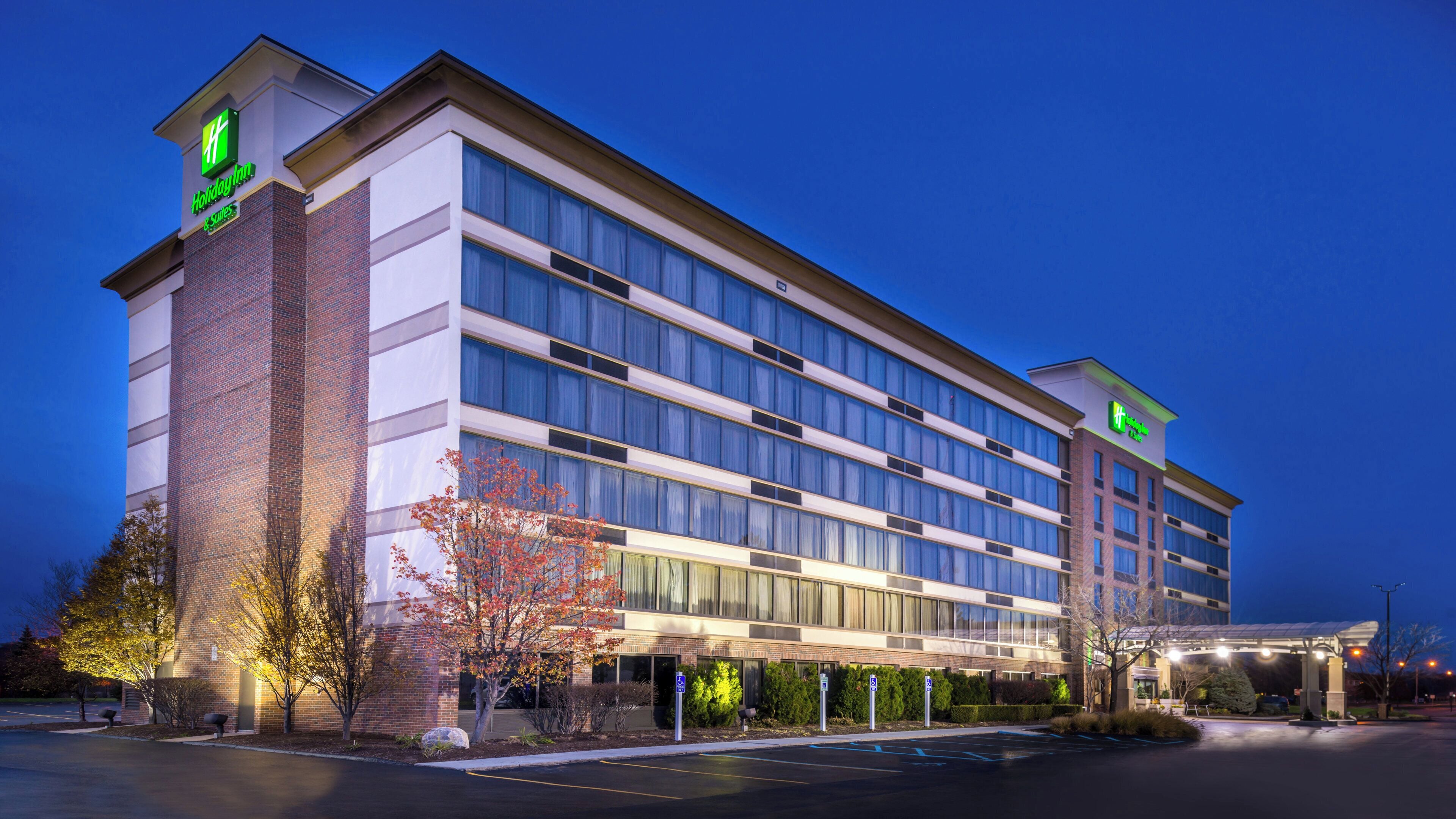 A multi-story hotel with a brick facade, large windows, and a Holiday Inn Express sign.