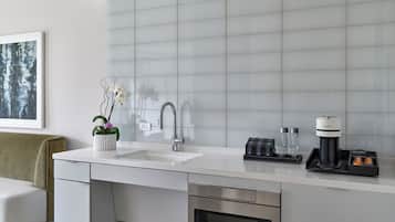 A modern kitchen with a white countertop, stainless steel appliances, and a built-in oven.