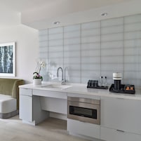A modern kitchen with a white countertop, stainless steel appliances, and a built-in oven.
