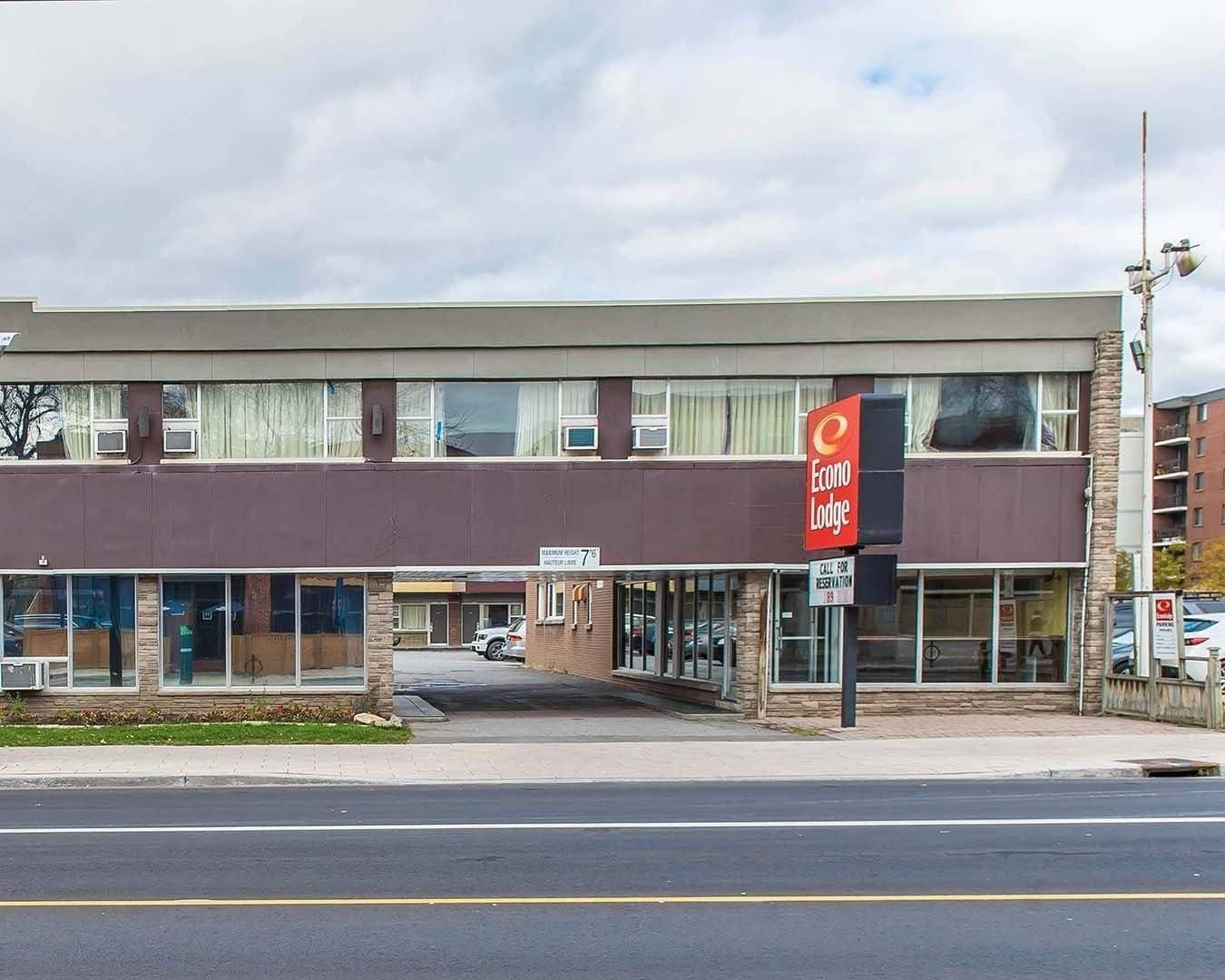 A two-story Econo Lodge building with a brown facade, large windows, and a visible parking area.