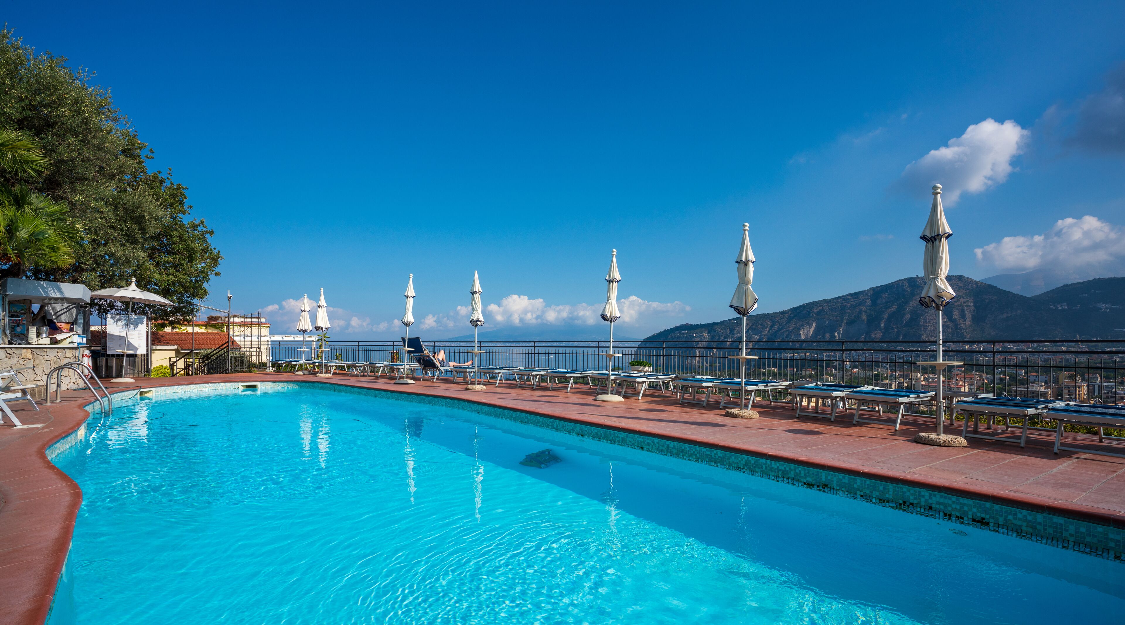 outdoor pool, open 9 am to 7 pm, pool umbrellas, pool loungers