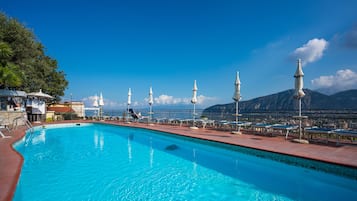 Outdoor pool, open 9 AM to 7 PM, pool umbrellas, pool loungers