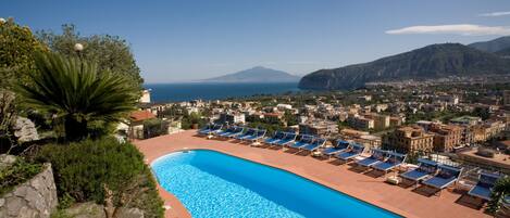 Outdoor pool, open 9 AM to 7 PM, pool umbrellas, pool loungers