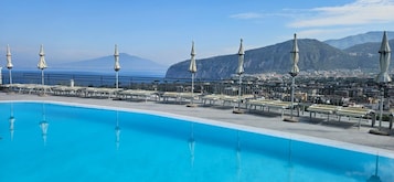 Outdoor pool, open 9 AM to 7 PM, pool umbrellas, pool loungers