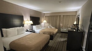 A hotel room with two beds, a desk, a chair, and a minibar. - Quality Inn & Suites Cincinnati Downtown Area (Cincinnati)