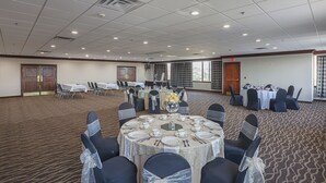 A conference room with round tables, chairs, and a carpeted floor. - Quality Inn & Suites Cincinnati Downtown Area (Cincinnati)