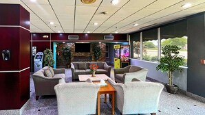 A lobby with seating, an ATM, and a claw machine. - Quality Inn & Suites Cincinnati Downtown Area (Cincinnati)