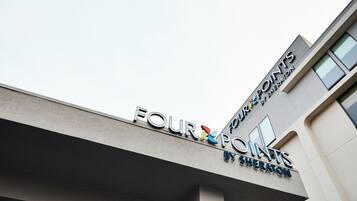 A building with a sign that reads 'FOUR POINTS BY SHERATON'.