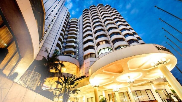 A high-rise hotel with multiple balconies and a modern architectural design. - Nairobi Safari Club by Swiss-Belhotel (Nairobi)