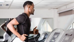 A person running on a treadmill in a gym with multiple treadmills and a control panel. - Nairobi Safari Club by Swiss-Belhotel (Nairobi)