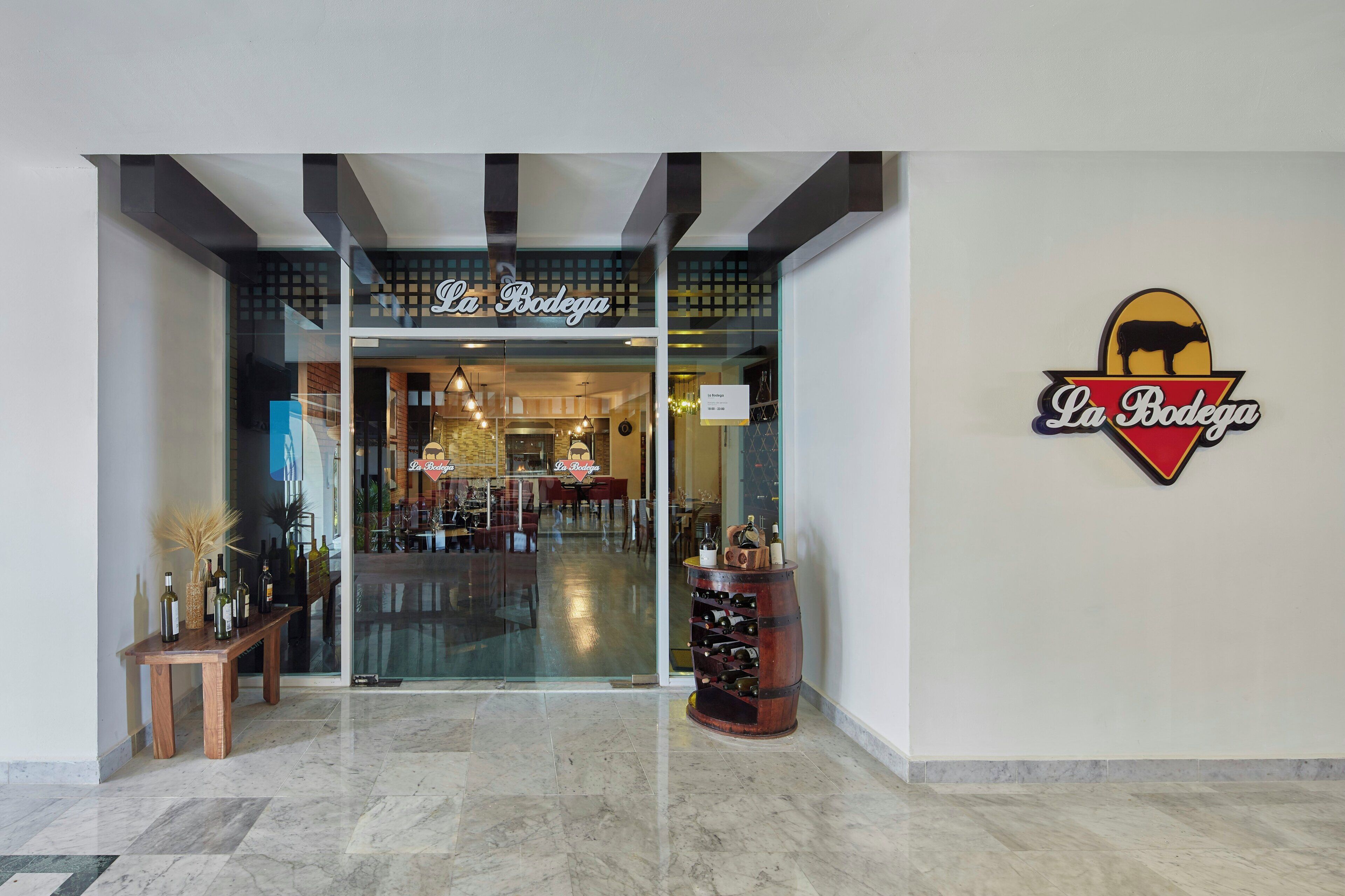 The entrance to La Bodega with a wine display outside.
