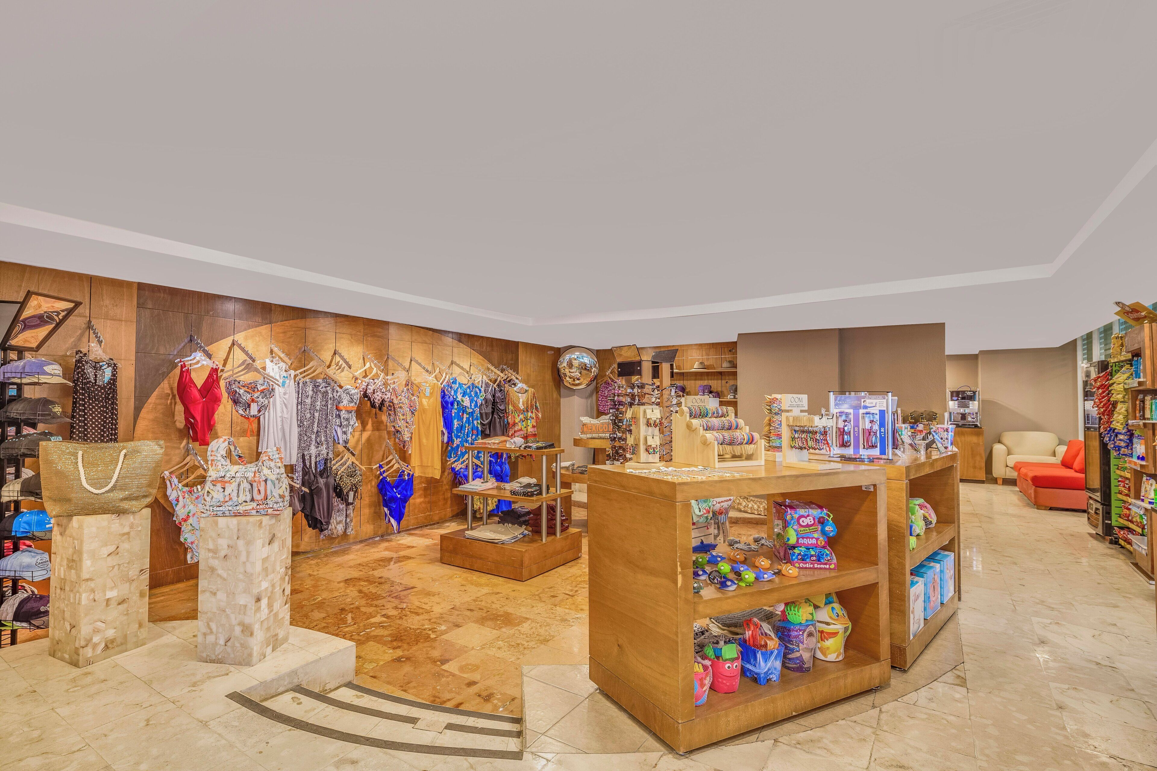A boutique with clothing racks, a jewelry display, and shelves with various items.